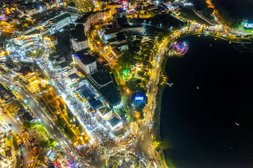 Aerial view of Da Lat city night beautiful tourism destination in central highlands Vietnam. Urban development texture, green parks and city lake.