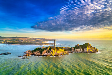 Landscape of small island with ancient lighthouse at sunrise sky is beautiful and peaceful. This is only ancient lighthouse is located on island in Vietnam