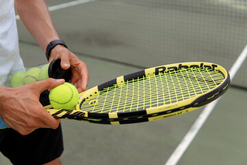 close-up. male hands holding tennis racket and balls