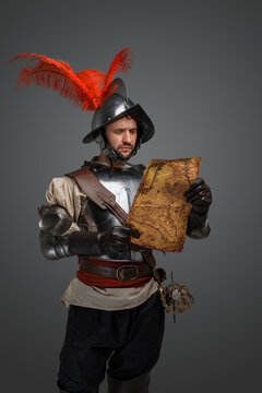 Studio Shot Of Isolated On Gray Background Conquistador With Map.