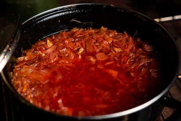 Saucepan with red Ukrainian borscht. The national dish is a soup of cabbage, beets and vegetables in meat broth.