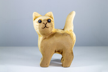 Wooden cat figurine isolated on white background. Handmade.