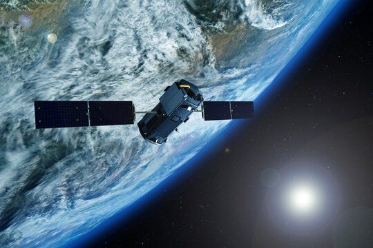 Space communications satellite above the earth. Elements of this image furnished by NASA