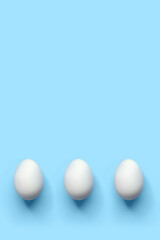 Minimalist Easter greeting or advertising card template, white eggs on blue background, mockup with copy space