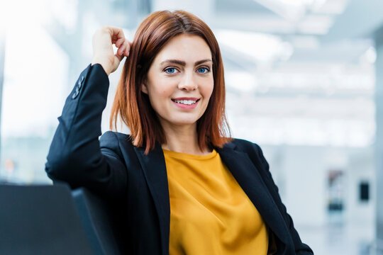 Portrait of smiling redheaded businesswoman