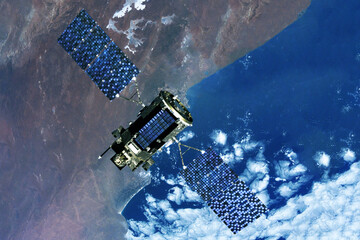 Space communications satellite above the earth. Elements of this image furnished by NASA