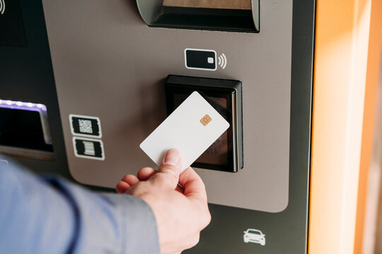 Hand of businessman with credit card using ticket machine