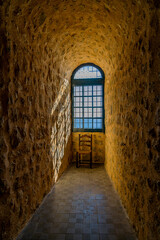 background illuminated window by the sun in a stone old castle and drawnianum with a chair background
