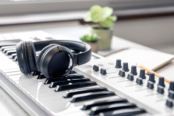 Close up, headphones on midi keyboard, music concept.