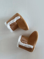children's brown boots are scattered on a white background. children's winter fashion. view from above. copy space