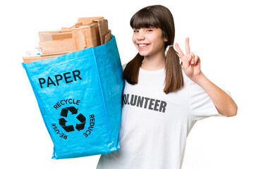 Little Caucasian girl holding a recycling bag full of paper to recycle over isolated background...
