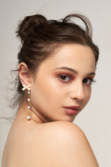 Close-up shot of a charming European girl with a natural make-up. Youthful charm is emphasized by...