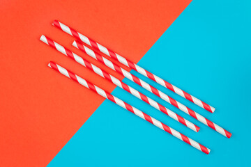 Drinking straws for party on colored background, flat lay.