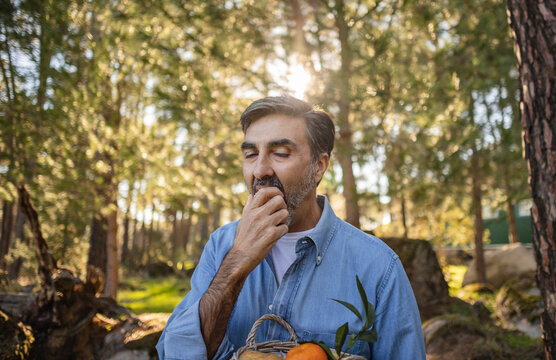 Mature Man Eating A Fruit