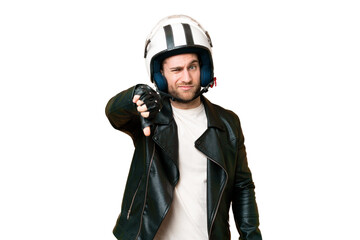 Young handsome blonde man with a motorcycle helmet over isolated chroma key background showing thumb down with negative expression