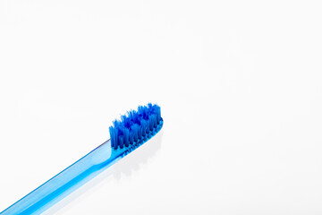 Translucent toothbrush with colored bristles.