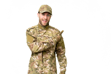 Military man over isolated chroma key background surprised and pointing side