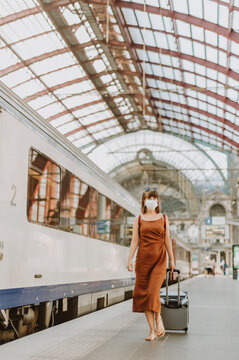 Tourist woman with mask walking inside Antwerp train station