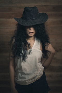 Curly hair girl in cowboy hat