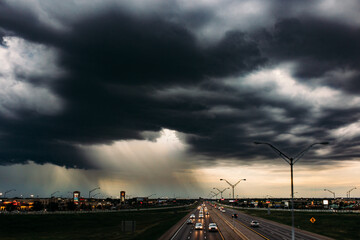 Clouds opening with rain falling over the city