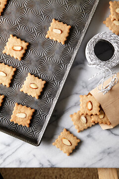 holiday almond cookies on vintage baking tray and packaging