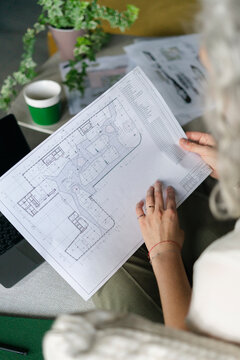 Architect working on floor plan in office