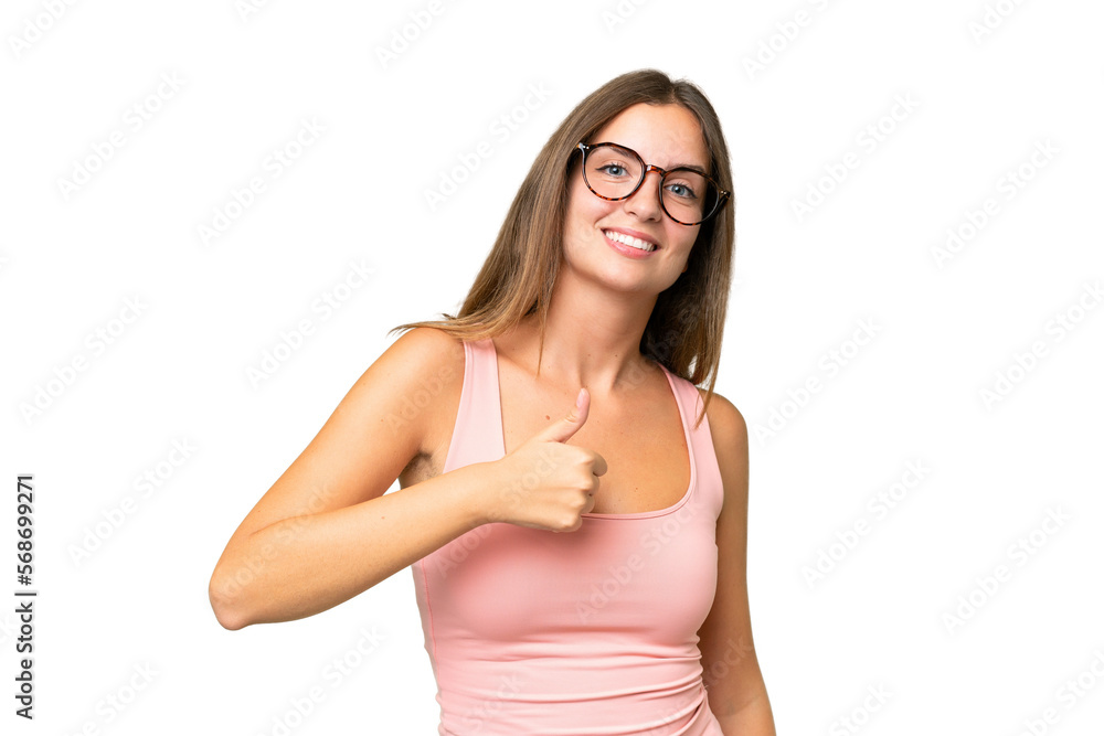 Wall mural Young pretty woman over isolated background giving a thumbs up gesture