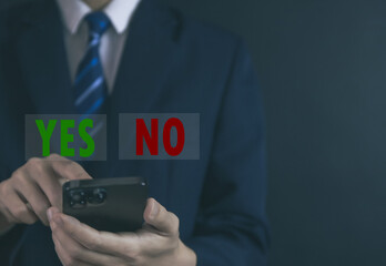 Businessman using smartphones show yes or no.	
