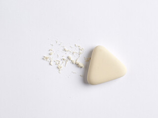 To erase, correct or fix a mistake or error concept. White eraser in triangle shape with scraps