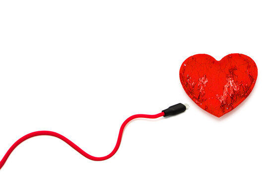 Red heart connected to usb cable isolated on white background.