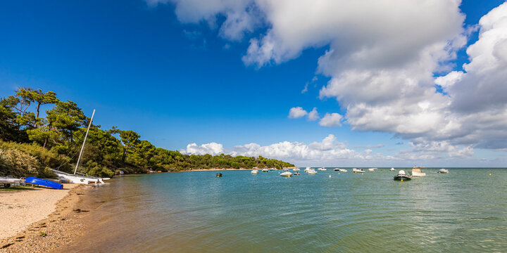 France, Nouvelle-Aquitaine, Les Portes-en-Re, Summer clouds over boats floating near shore of Ile de Re island - Powered by Adobe