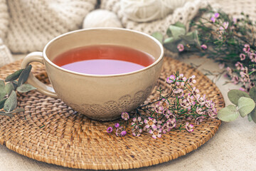 Close-up, big cup of tea and flowers, cozy composition.