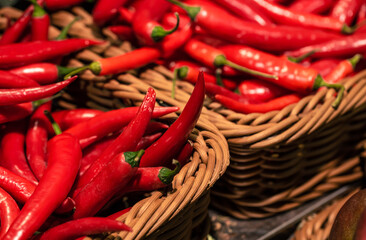 Chili peppers in a basket in a supermarket, close-up.