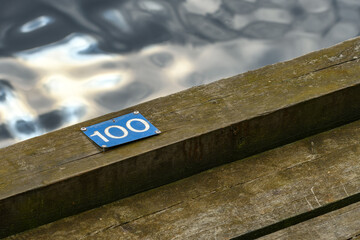 Nissan river wooden quay numeration plates in Halmstad, Sweden. Number 100.