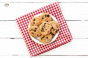Chocolate chip cookies on a wooden background, flat lay.