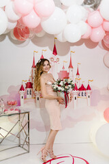 Beautiful girl holding bouquet flowers, luxury princess in pink dresses. Fashion lady in gorgeous...