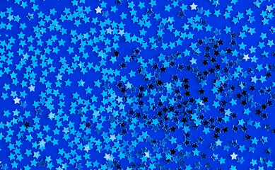 Shiny stars with golden glitter on a blue background. Flat style. Festive background.
