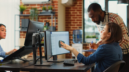 Man and woman brainstorming ideas to create new industry software on computer, looking at engine component. Office employees working on creative content production, professional job.