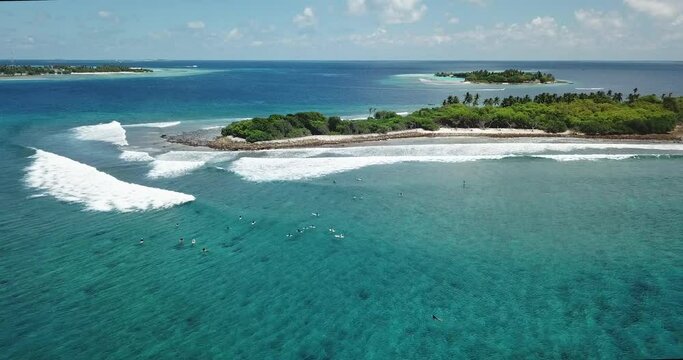 Drone shot of people with surfboards in sea against sky