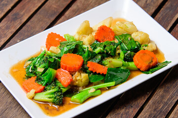 Fried stri mixed vegatable with oyster sauce on the white dish.