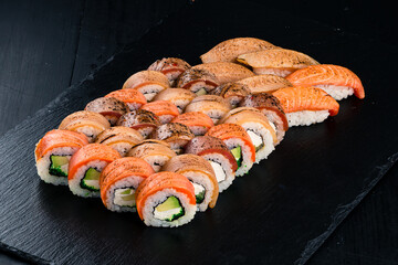 Japanese lunch sushi rolls and nigiri with tuna, salmon, eel, tobiko caviar, cream cheese, avocado, mango and chuka seaweed.