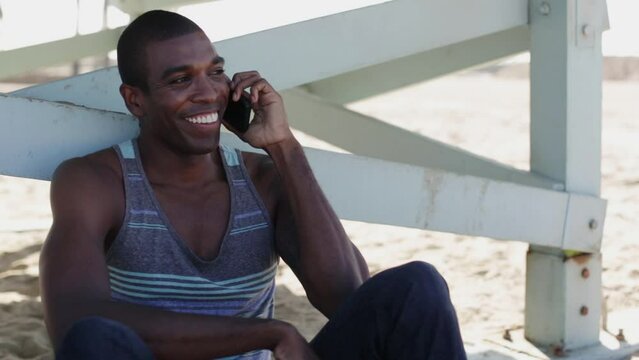 Man talking on cell phone while on beach