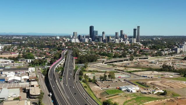 Busy M4 toll road motorway in Sydney West near Parramatta city – aerial flying as 4k.
