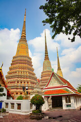 Fototapeta premium Golden stupa's of Wat Pho, or Wat Po, the Buddhist temple in the Phra Nakhon District, Bangkok, Thailand.