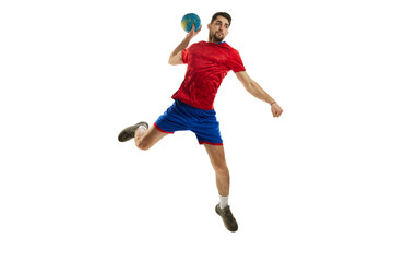 Obraz na płótnie Canvas Throwing ball in a jump. Young man, professional handball player in red uniform playing, training isolated over white studio background. Sport, action, motion, championship, sportive lifestyle concept