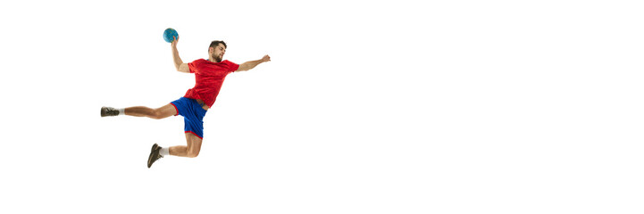 Young man, professional athlete playing handball isolated over white studio background. In motion. Concept of sport, action, motion, championship, sportive lifestyle. Banner. Flyer. Copy space for ad - obrazy, fototapety, plakaty