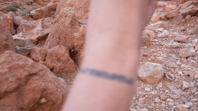 Man hiking rocky rugged canyon trail wearing shorts, Handheld Pov shot