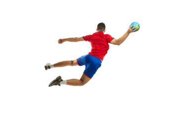 Back view studio shot in motion of young man, professional handball player training, playing isolated on white background. Dynamics. Concept of sport, action, motion, championship, sportive lifestyle
