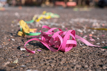 Colorful confetti and streamers at the street after Carnival show