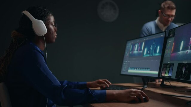 woman video editor making clip by movie editing software in computer in studio, post-production